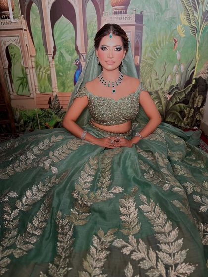 The full look, showcasing the beautiful organza lehenga. The makeup is elegant and perfectly complements the outfit.
