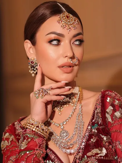 A close-up focusing on the intricate jewelry. I selected a multi-layered necklace and a delicate nath to complete this royal bridal look.