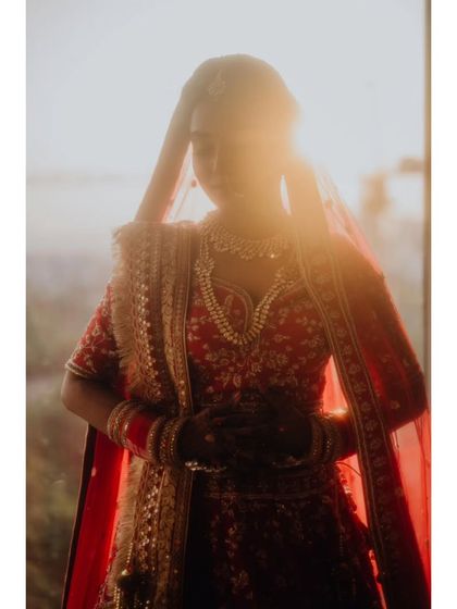 A dreamy, sun-flared portrait of the bride, creating a halo effect that makes her look absolutely ethereal.