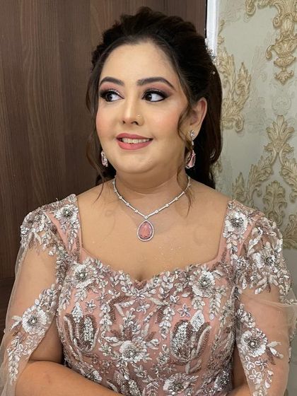 Another angle of this elegant party look, showcasing the intricate details of her outfit and the flawless makeup.