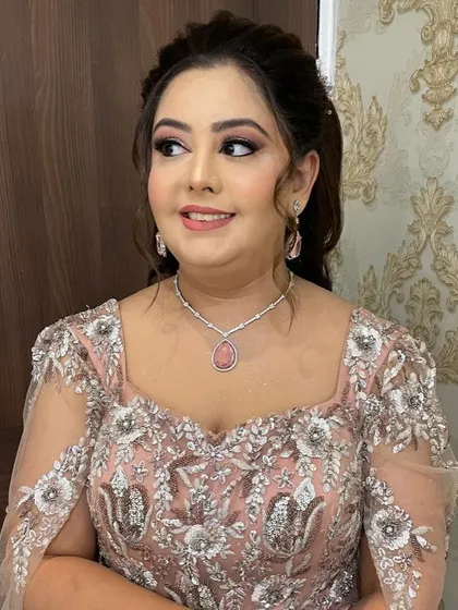 Another angle of this elegant party look, showcasing the intricate details of her outfit and the flawless makeup.
