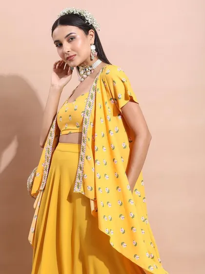 A full-length view of the yellow co-ord set with a matching cape. The styling is elegant and modern, perfect for a contemporary festive occasion.