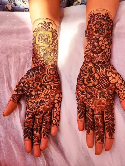A rich floral design for a groomsmaid, featuring a large, statement rose on the wrist.