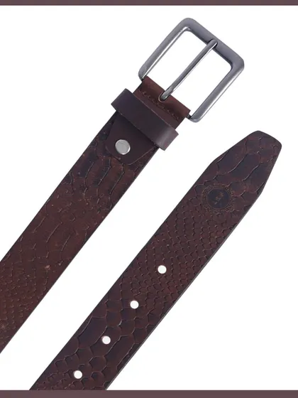 A close-up of the textured leather and buckle of a men's belt.