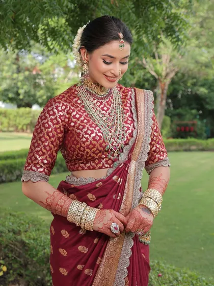 A candid moment capturing the bride's happy glow, with her intricate henna and traditional jewellery on full display.