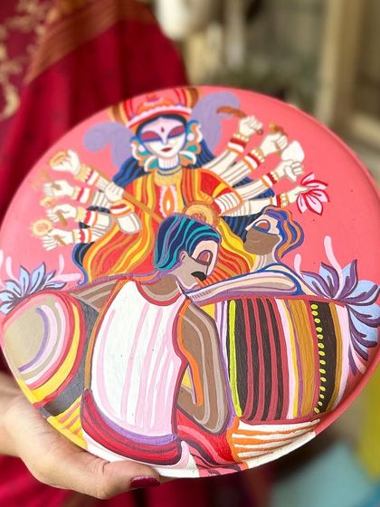 The Durga Pujo plate, featuring the goddess and 'dhakis' (drummers).