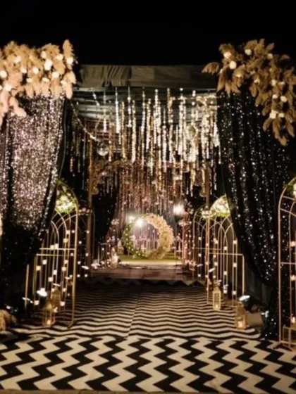 I love creating dramatic entrances. This glamorous Sangeet night entryway features a black and white chevron floor, sparkling drapes, and warm fairy lights, setting a chic and exciting tone for the evening.