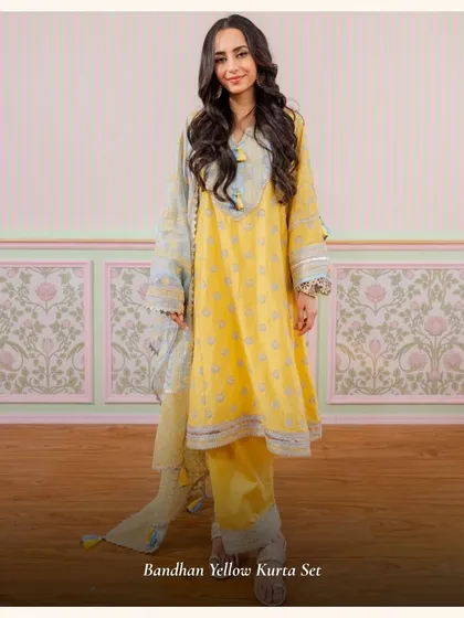 The Bandhan Yellow Kurta Set is a beautiful piece with a contrasting blue dupatta. The playful tassels and comfortable fit make it perfect for a relaxed festive look.