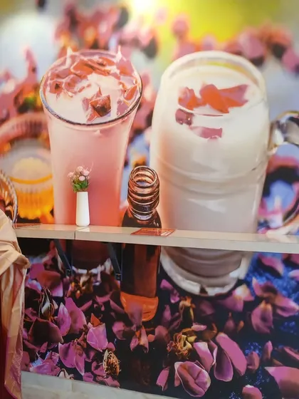 To reinforce the cafe's brand, we created a custom wall graphic featuring their signature rose milk drinks. This not only adds a pop of color but also serves as a great marketing element within the space.