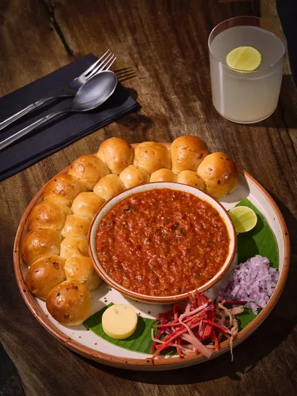 This is my take on a Mumbai icon, the Pav Bhaji. I serve it with a ring of soft, oven-fresh buttered paos, a rich and deeply spiced bhaji, and a dollop of herb butter. It’s a crowd favourite for a reason.