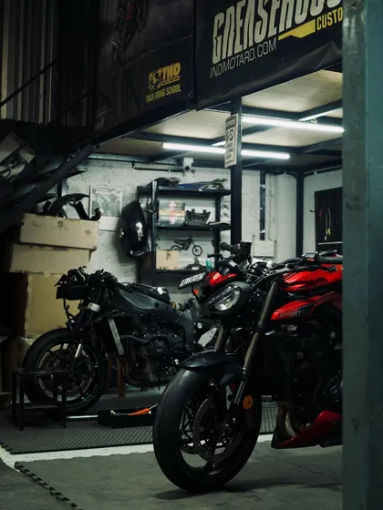 The garage is buzzing with activity as we get bikes ready for the TWO track day. Here's a stripped-down bike next to a Triumph Street Triple.