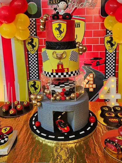 The grand 4-tier Ferrari cake, complete with a garage, a trophy tier, and lots of racing details.