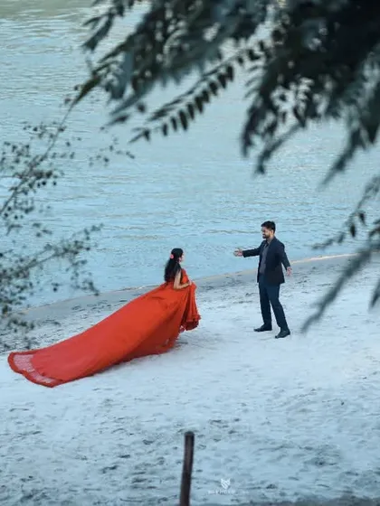 A playful interaction on the beach, with him reaching out to her. This captures a candid, story-like moment.