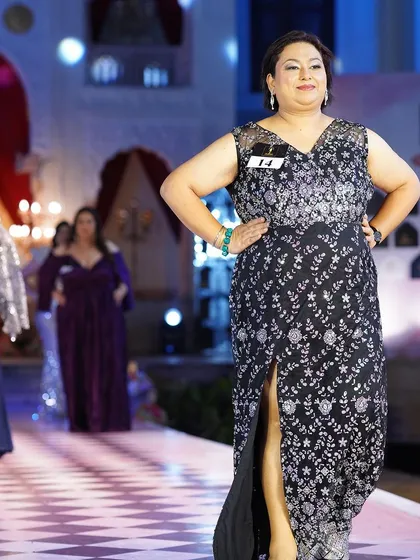 A black and silver embroidered plus-size gown with a thigh-high slit. It’s a perfect blend of elegance and allure.