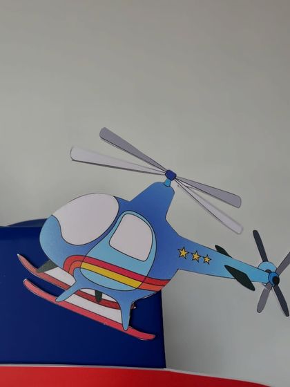 A close-up of a helicopter cutout, part of the adventurous travel-themed gift.
