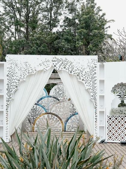 The entrance to the sangeet, featuring a stunning Thikri work facade. This grand entryway sets the tone for the evening, promising a night of intricate beauty and celebration.