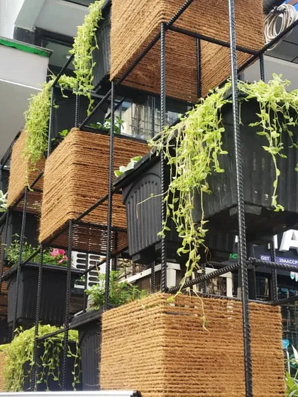 This vertical garden uses a custom metal frame with coir-wrapped planters. The design is rustic yet modern, and the trailing plants add a wonderful cascading effect, bringing a lot of greenery to a small footprint.