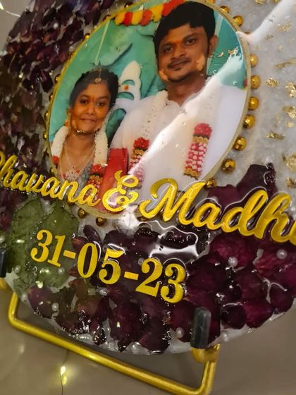 Here is a beautiful circular resin frame preserving a couple's varmala flowers. I added their photo, names, and wedding date to make it a truly personal piece of decor for their home.