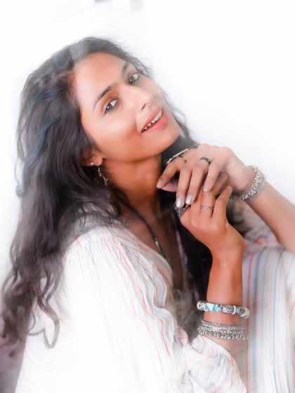 A bright, high-key portrait that feels light and airy. The soft focus and gentle smile contribute to a dreamy, bohemian vibe that is both beautiful and free-spirited.