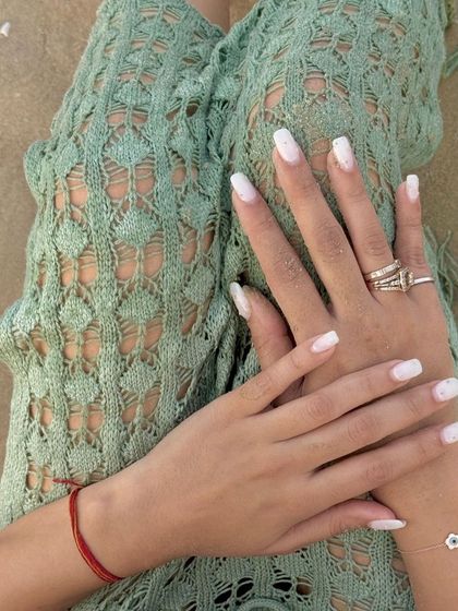 A day at the beach featuring a lovely white manicure.