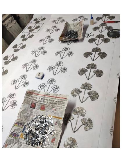 Another angle of the Thikri panel creation, showing multiple templates and the sheer quantity of glass pieces involved.