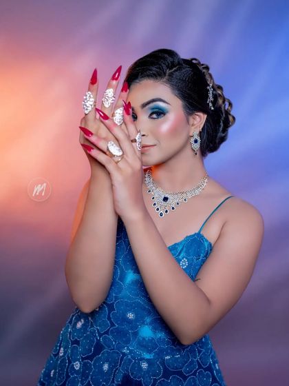 A playful pose that highlights the long, decorative nails and the beautiful rings available to rent with our outfits.