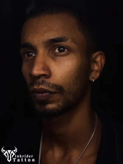 A moody portrait showcasing a subtle nose stud. Even small piercings can make a big impact on your look.