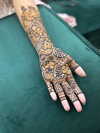 A lovely design for the bride's sister, featuring a mix of floral and geometric patterns that are not as dense as a full bridal look.