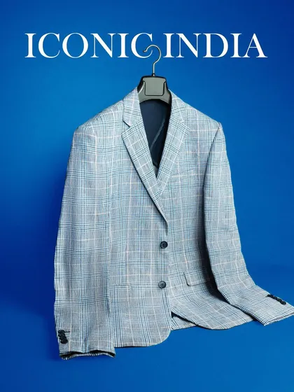 A professional apparel shot of a blazer from Iconic India against a solid blue background. This "hollow man" style is widely used for e-commerce and catalogs.