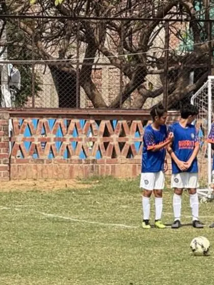 A U13 player lining up a free kick during a match.