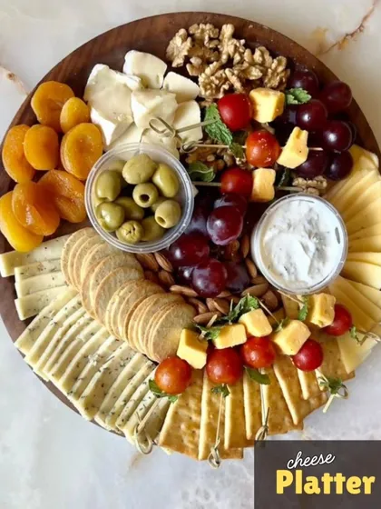 My vegetarian Cheese Platter is designed for elegant snacking. It features a curated selection of artisanal cheeses, paired with crisp crackers, nuts, dried apricots, fresh grapes, and olives for a perfect balance of sweet and savory flavors.
