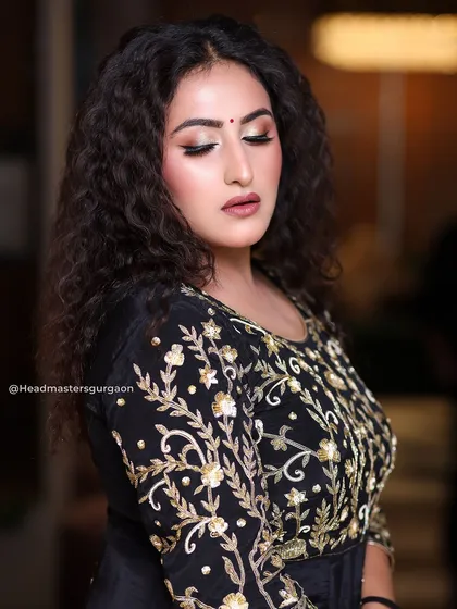 A close-up of the makeup from our curly-haired model shoot. The focus is on the expertly blended eyeshadow and the soft, matte finish on the skin.