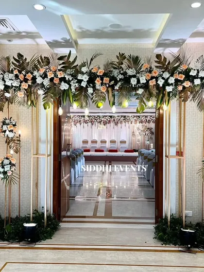 First impressions are everything. We designed this grand entrance with elegant floral arrangements in peach and white, accented with warm lighting, to welcome guests into a world of romance and celebration.