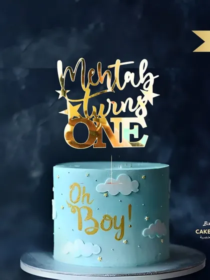 A first birthday is a huge milestone! This "Mehtab turns ONE" topper in a glossy gold finish looks fantastic on this "Oh Boy!" themed cake, showing how a custom piece can tie your whole party theme together.