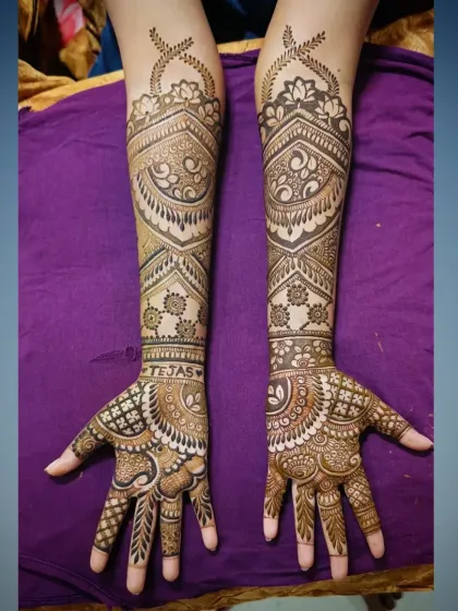 A clear, top-down photo of the "Tejas" mehandi, showing the detailed work on the palms and forearms.