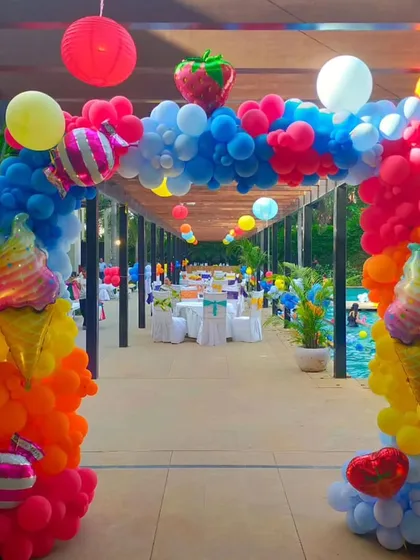 The entrance to Kiara's pool party featured this incredible balloon arch. I used bright, summery colours and added fun foil balloons shaped like ice cream cones and strawberries to perfectly match the fun-in-the-sun theme.