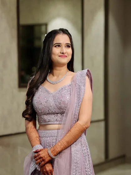 A beautiful solo portrait of the bride in her lilac lehenga, showcasing her soft, glowing makeup.