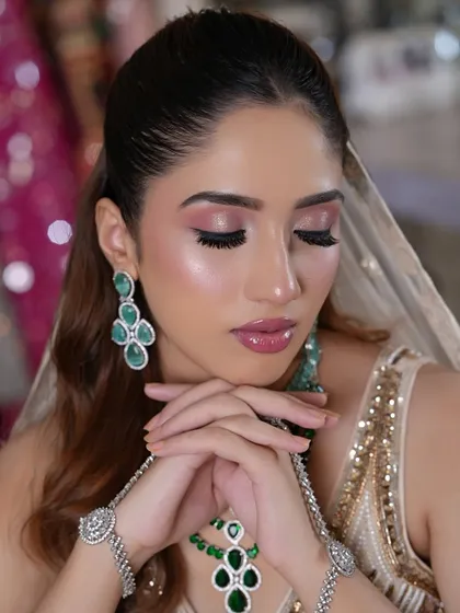 Eyes closed to showcase the soft blend of pink and neutral tones on the eyelid.