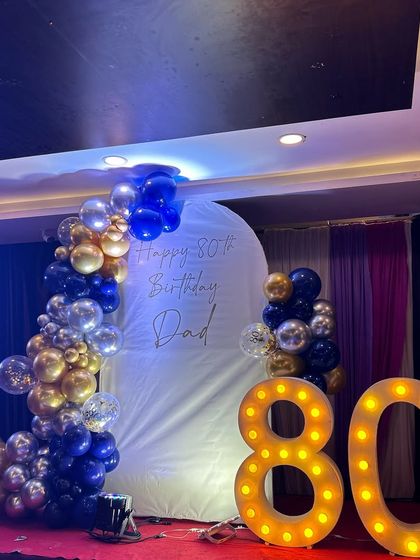 The complete stage setup for the 80th birthday party, ready for the guest of honor and his family.