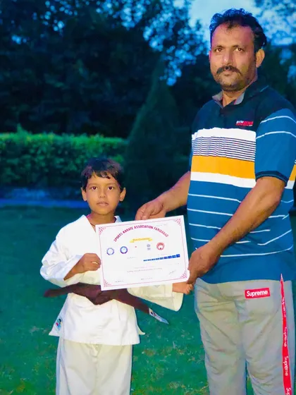 This young boy has earned his brown belt, a remarkable achievement for his age. His potential is limitless.