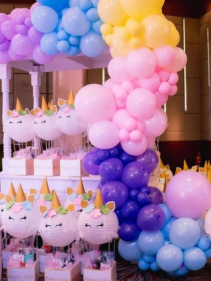 These adorable unicorn-themed return gifts are ready for the little guests. We used paper lanterns and custom balloon arrangements to create a fun and colorful giveaway station.