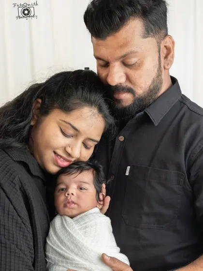 A beautiful family portrait, with your baby awake and nestled safely between you. These are the first of many family photos to come, marking a truly special beginning.