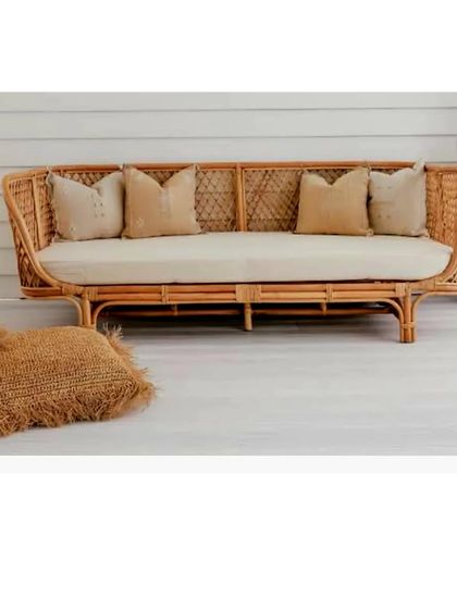 This three-seater rattan sofa features a beautiful cross-weave pattern on the backrest. It’s a durable, family-friendly piece that brings a touch of natural texture to your living room.