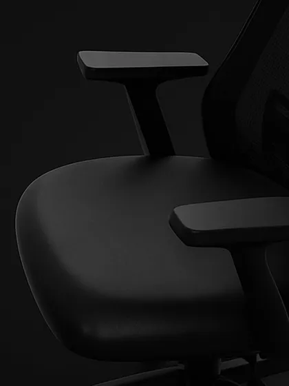This close-up focuses on the adjustable T-shaped armrests and the contoured seat of our ergonomic chair. These elements are designed to reduce strain on your shoulders and provide a comfortable seating foundation.