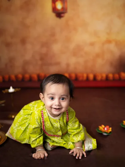 Capturing the crawling milestone during a festive shoot. This baby is on the move, exploring the Diwali setup with a big smile.