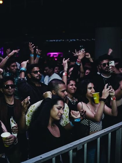 The front row of a club night, with guests fully immersed in the music. I ensure the sound system is perfectly tuned for an optimal listening experience.