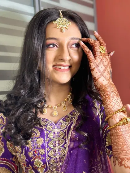 A happy, candid moment showing off the beautiful henna and the subtle, glowing makeup. This look is all about enhancing natural, youthful beauty.
