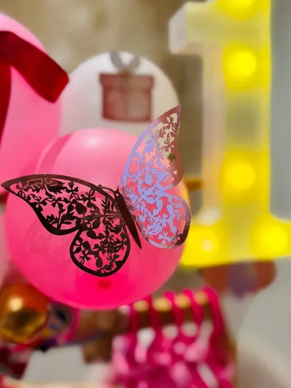 A delicate butterfly detail on a pink balloon, showing the small, magical touches I add to make each hamper unique.
