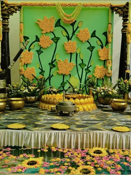A Haldi ceremony that radiates joy and tradition. We created this vibrant waterside setup featuring a custom backdrop of marigold lotuses, traditional brass vessels, and a floor of floating flowers, turning the entire space into a colorful celebration.