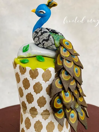 A side view of the peacock, showing the texture and layering of its beautiful tail.